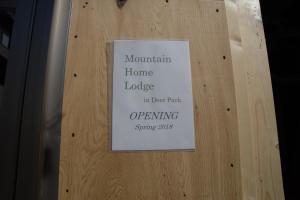 a sign on a wooden door with a sign on it at Mountain Home Lodge in Deer Park in Nara