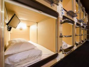 a bed in a room with a wall of mirrors at Tanegashima Araki Hotel in Nishinoomote