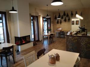 a restaurant with tables and chairs and a fireplace at Agriturismo Cascina del Poggio in Lurago Marinone