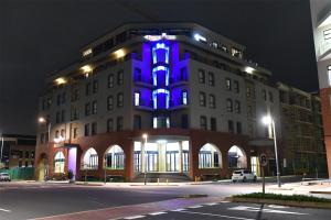 a building with a blue light on it at night at Regal Inn Umhlanga Gateway in Durban