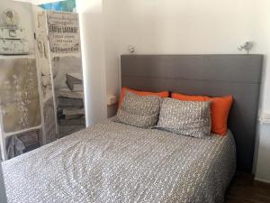 サンタクルス・デ・テネリフェにあるVacacional panorámica al mar centro Santa Cruzのベッドルーム1室(オレンジとグレーの枕が備わるベッド1台付)