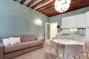 a living room with a couch and a table at Rialto Prestige - Campo S Maria Formosa by Wonderful Italy in Venice +22 photos