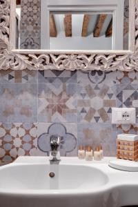 a bathroom with a white sink and a mirror at Rialto Prestige - Campo S Maria Formosa by Wonderful Italy in Venice