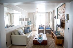 a living room with a couch and a table at Mylas Cottage in Swakopmund