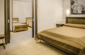 a bedroom with a bed and a mirror at Hotel Grazia Eboli in Eboli