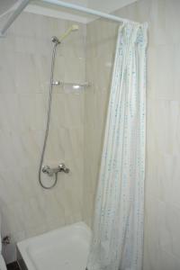 a bathroom with a shower with a shower curtain at Central Suite in Funchal 1N in Funchal