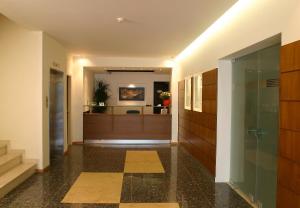 a hallway with a pivot door in a building at Blue Sea Hotel Alimos in Athens