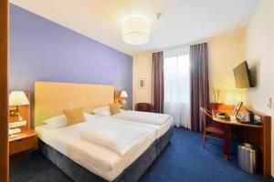 Кровать или кровати в номере Austria Classic Hotel Wien