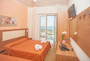 Postel nebo postele na pokoji v ubytování Hotel Sara