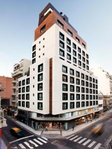 a tall white building on a city street at Hotel Pulitzer Buenos Aires in Buenos Aires