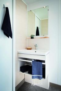 ein Badezimmer mit einem weißen Waschbecken und einem Spiegel in der Unterkunft Camping Village Città di Milano in Mailand