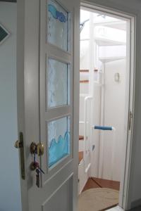 a door with a glass window in a room at Casa Adriana Fronte Mare in Monopoli