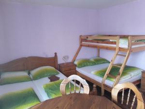 a room with two bunk beds and a table at Ubytování u Kubů in Jablonec nad Nisou