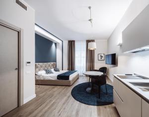 a bedroom with a bed and a table in a room at Estella luxury suites in Turin