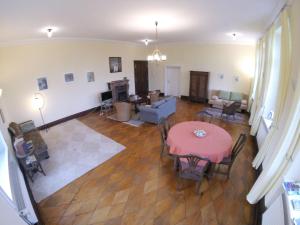 an aerial view of a living room with a table and chairs at Schloss Lelkendorf - Fewo Prebberede in Lelkendorf