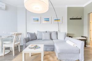 a living room with a couch and a table at ATLANTIC GARDENS 134 Condominium in Cascais