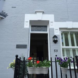 a white house with flower pots on a fence at Midsummer House in Stratford-upon-Avon