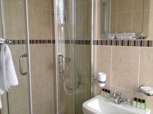 a bathroom with a shower and a sink at Balham Lodge in London