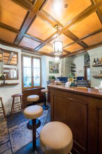 a restaurant with a bar with stools in a room at Auberge du Raisin in Cully