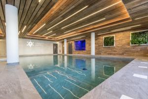 a pool in a building with a ceiling at Chalet de l'Ours in Arc 2000