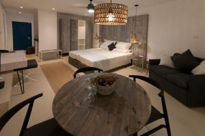 a living room with a table and a bed and a couch at Hylatio Tourist Village in Pissouri