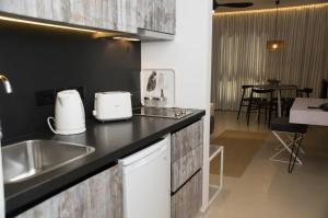 a kitchen with a sink and a counter top at Hylatio Tourist Village in Pissouri