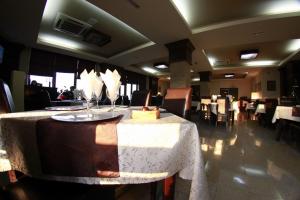 a restaurant with a table with a cake on it at Hotel Imperium in Suceava +24 photos