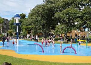 a group of people playing in a water park at Cannon House in Weston-super-Mare