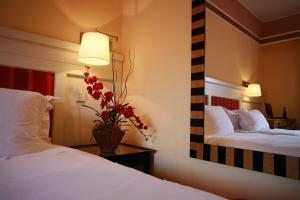 a hotel room with two beds and a mirror at Pestana Sintra Golf Resort & SPA Hotel in Sintra