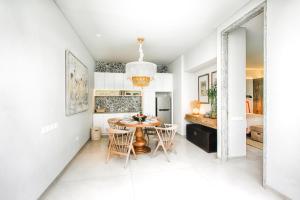 a kitchen and dining room with a table and chairs at Casamaya Villa in Legian