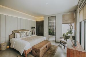 a bedroom with a bed and a sliding glass door at Casamaya Villa in Legian +23 photos
