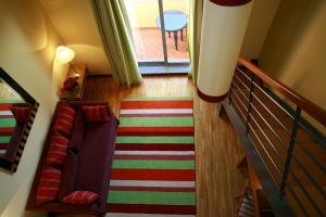 a hallway with a staircase with a couch and a rug at Pestana Sintra Golf Resort & SPA Hotel in Sintra