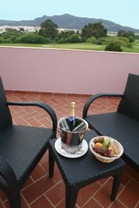 a table with a bottle of wine and a bowl of fruit at Pestana Sintra Golf Resort & SPA Hotel in Sintra