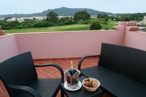 a balcony with two chairs and a table with a bowl of fruit at Pestana Sintra Golf Resort & SPA Hotel in Sintra