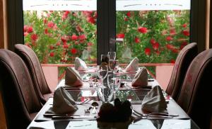 a table with glasses and napkins on top at Pestana Sintra Golf Resort & SPA Hotel in Sintra