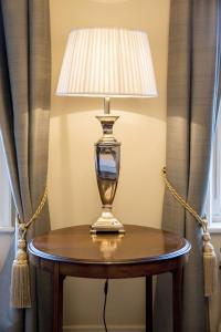 a table with a lamp on top of it at Grays Court Hotel in York