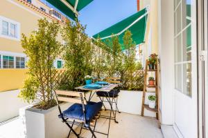 a patio with a table and chairs on a balcony at PATEO DA RAINHA - Apartment in Monte Estoril