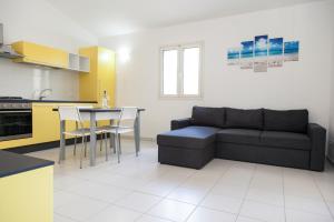 a living room with a couch and a table at San Teodoro in San Teodoro +13 photos