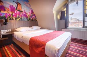 a hotel room with a bed and a painting on the wall at Mozart Hotel in Amsterdam