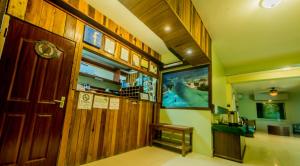 a hallway with a large wooden door in a house at Caye Caulker Plaza Hotel in Caye Caulker