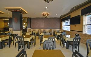 a dining room with tables and chairs in a restaurant at Hôtel Suite Martil in Martil