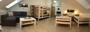 a living room with a couch and bunk beds at Sobe-Rooms Kvatric in Zagreb