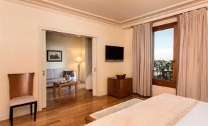 a hotel room with a bed and a window at Gran Hotel La Florida G.L Monumento in Barcelona
