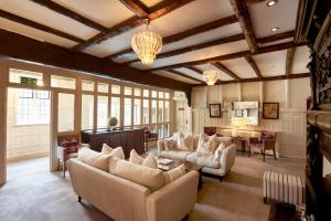 a large living room with couches and a table at The Manor Elstree in Elstree +31 photos