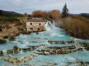 an aerial view of a river with a waterfall at Saturnia Pian Di Cataverna in Saturnia