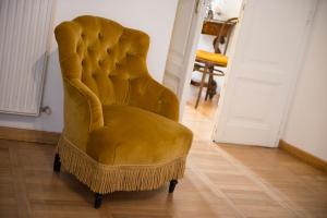 a yellow chair sitting in a living room at B&B La Scalinatella in Rome