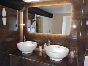 a white sink sitting under a mirror in a bathroom at Longbridge House in Shepton Mallet