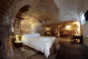 Ένα ή περισσότερα κρεβάτια σε δωμάτιο στο Albergo Diffuso Il Casale