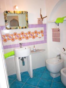 a bathroom with a sink and a toilet at Le Case dei Pescatori - Mare Blu in Ponza +10 photos