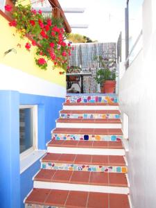 a stairway with colorful tiles and flowers at Le Case dei Pescatori - Mare Blu in Ponza